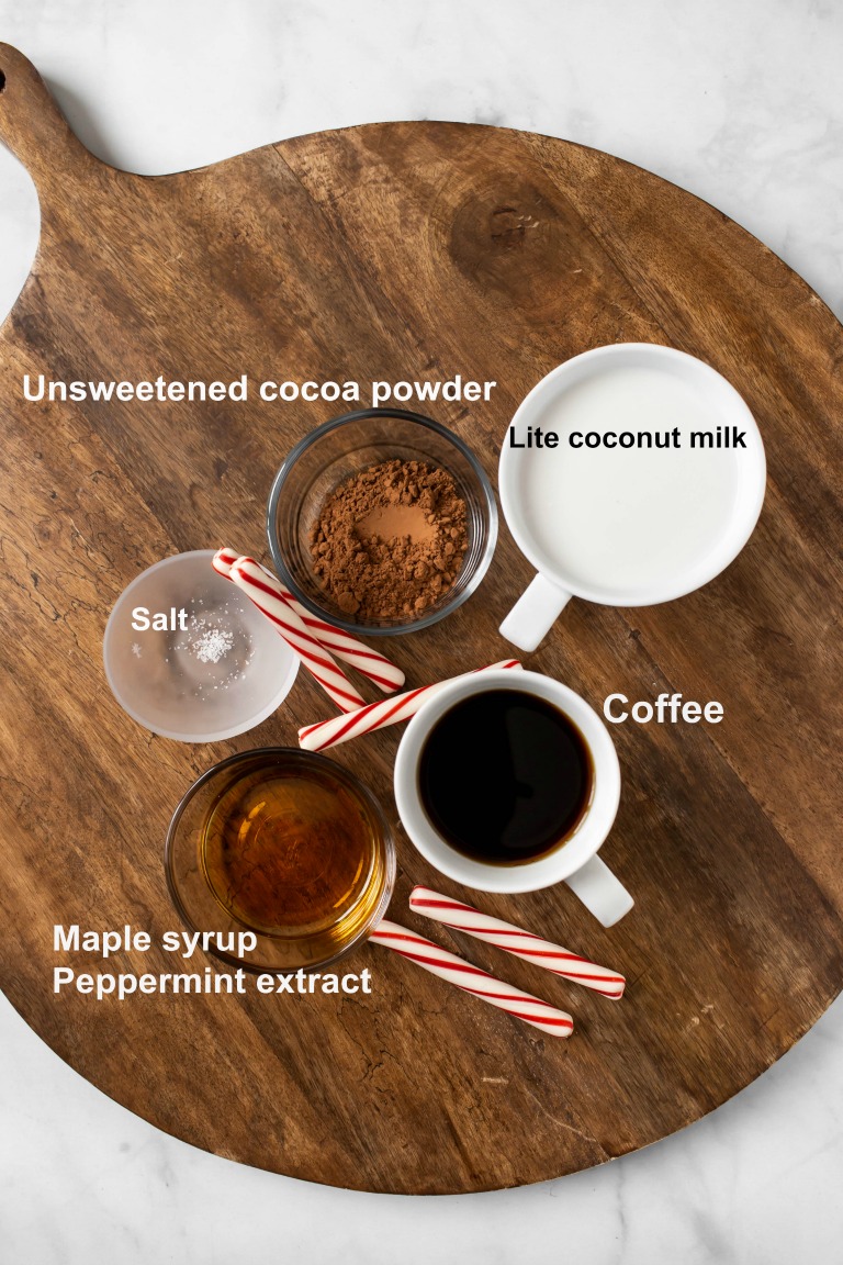 individual ingredients for vegan peppermint mocha latte on wood serving platter