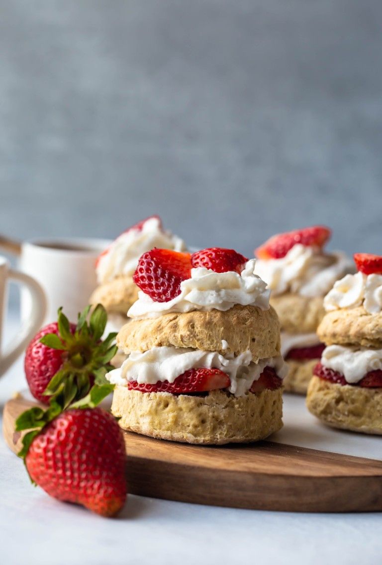 stacked shortcake with whipped cream and strawberries layers on biscuits
