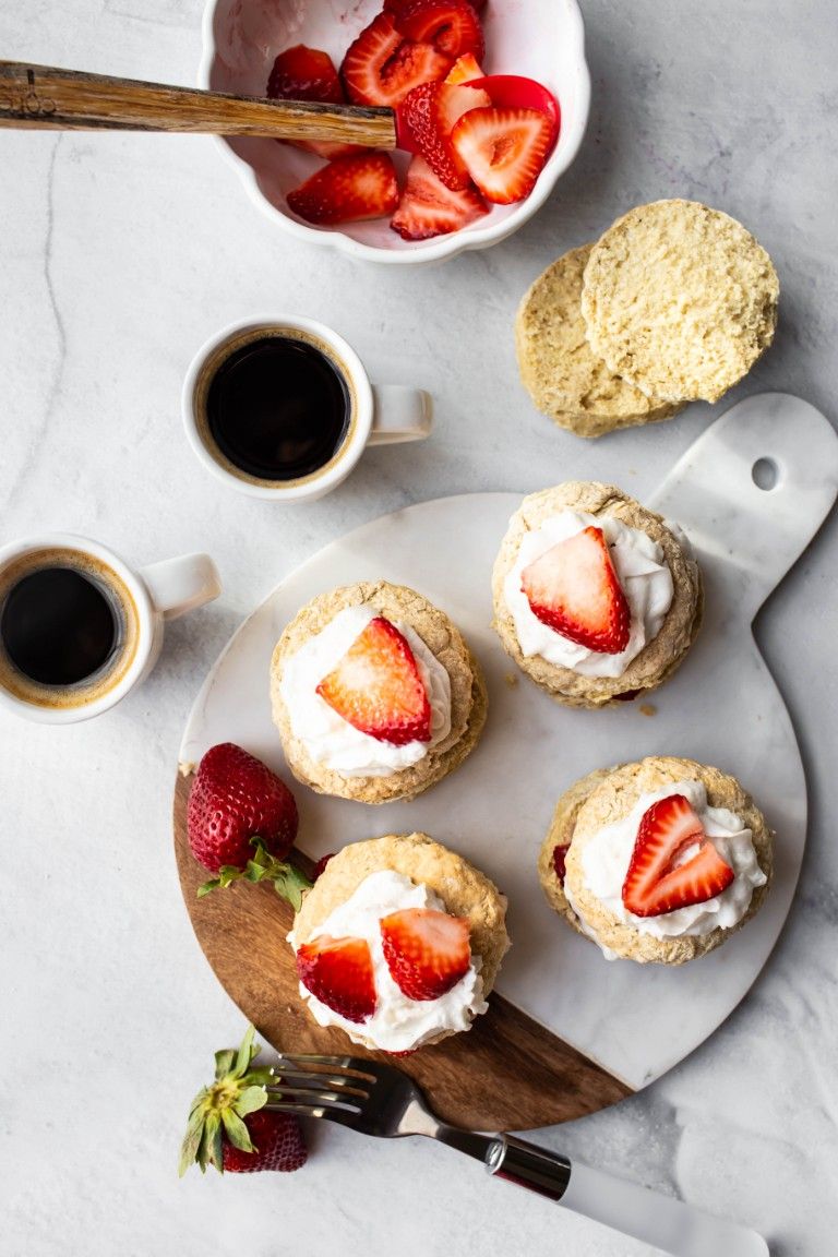 overhead image of shortcakes with whipped cream and strawberries and coffee