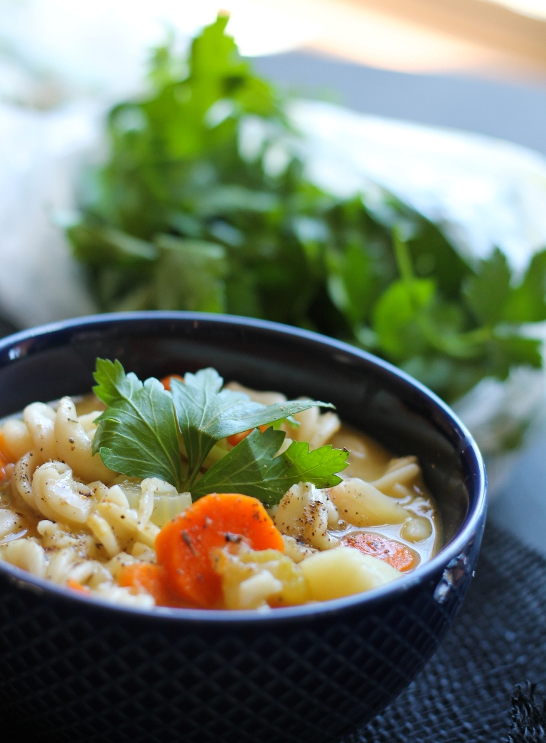 closeup of soup in dark navy blue bowl